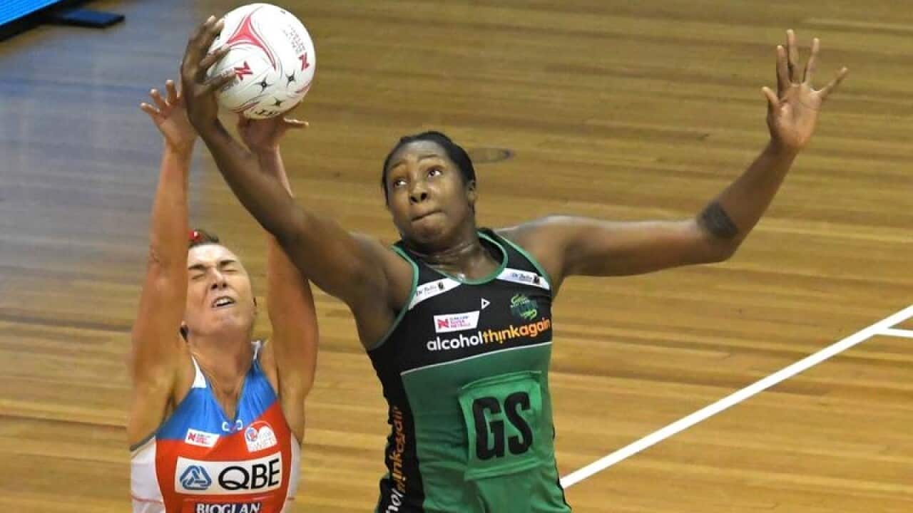 Jhaniele Fowler of the fever competes with Swifts, Kate Eddy.
