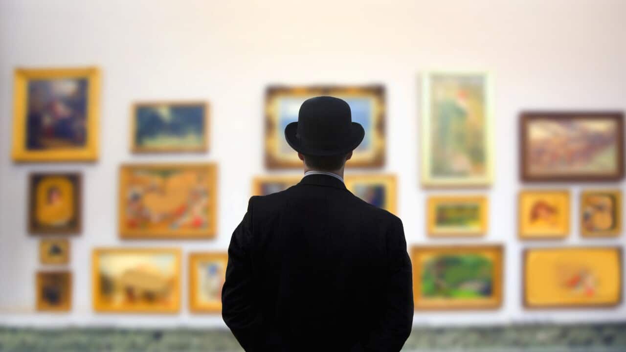 Man wearing Bowler hat in gallery