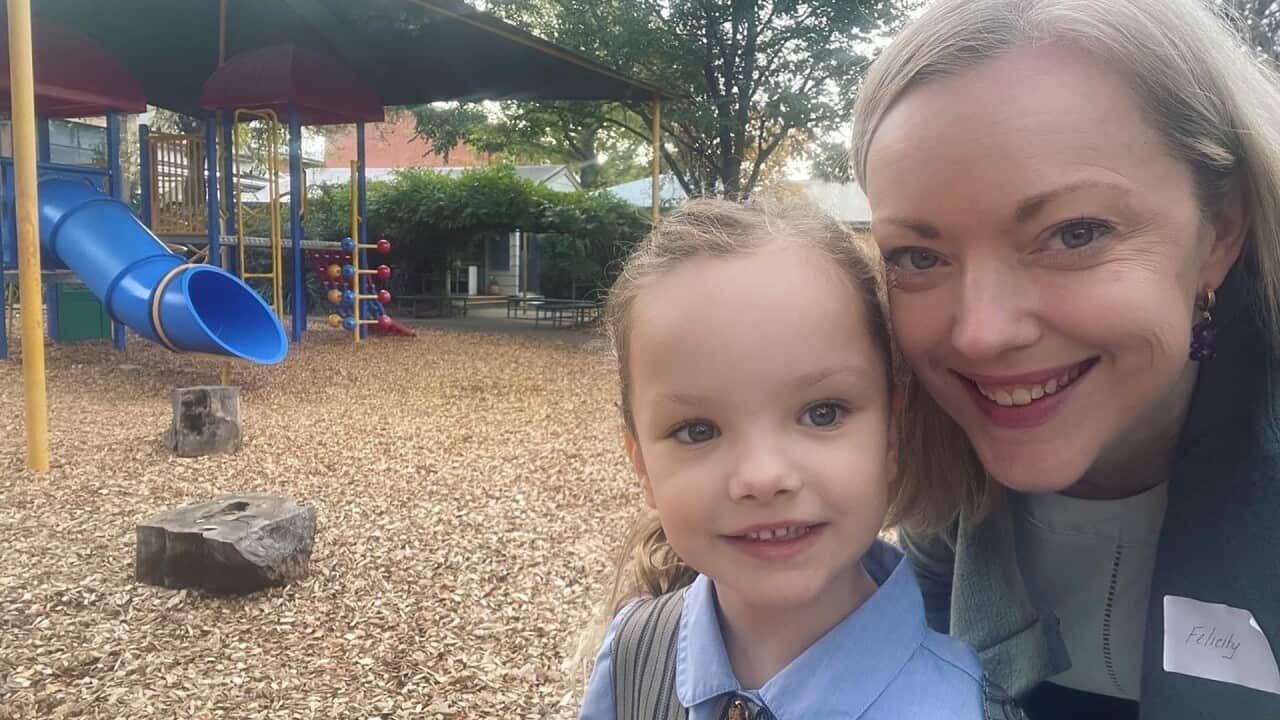 A parent with her child at a playground.
