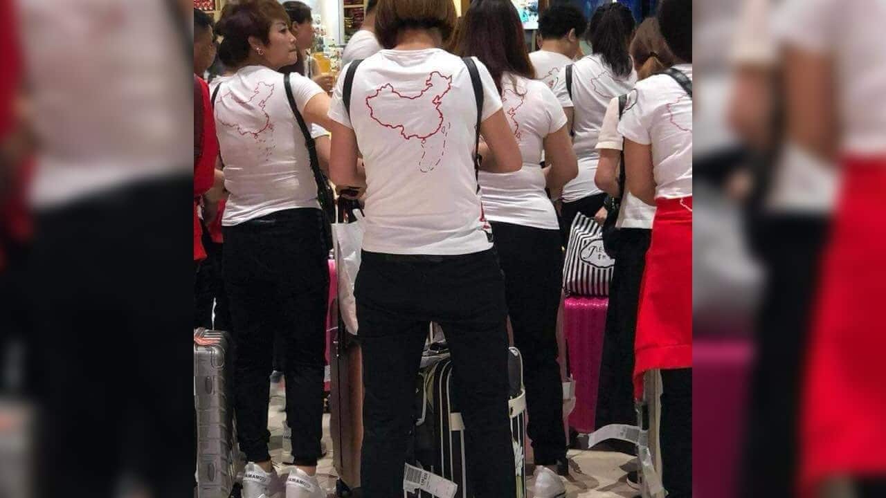 Chinese tourists are spotted in T-shirts with controversial South China Sea territory map