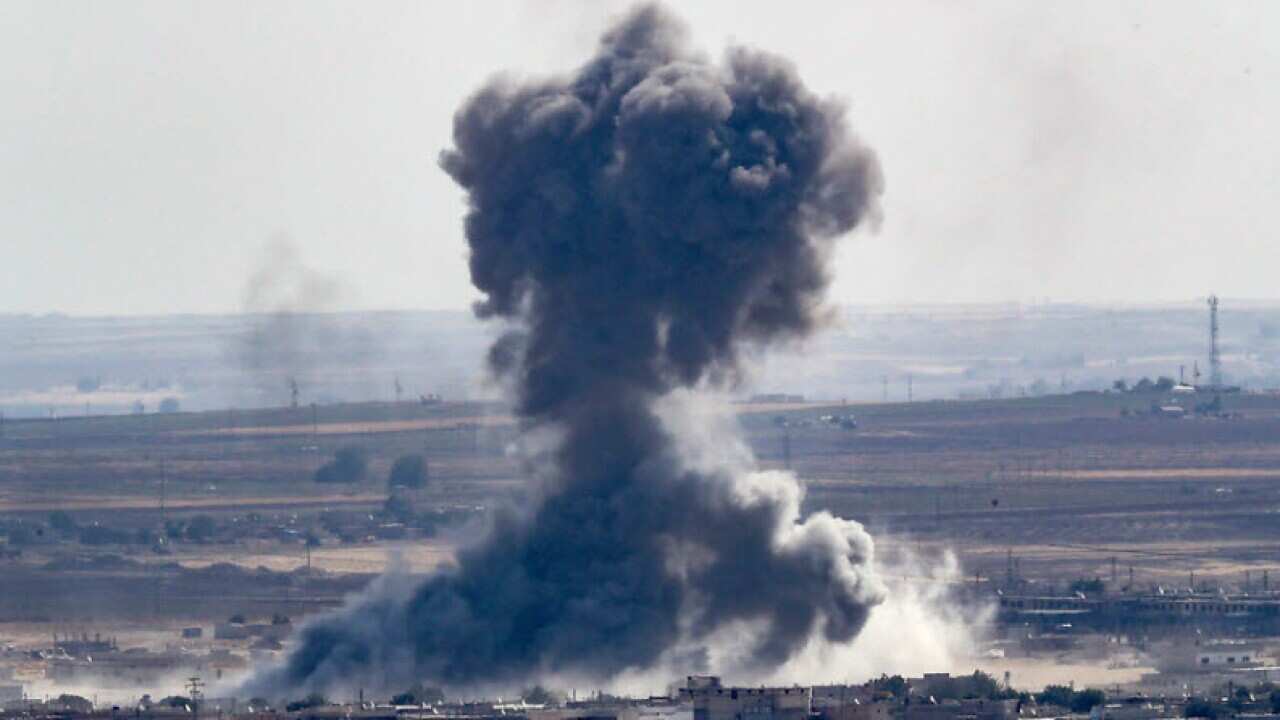 Smoke rises over the Syrian town of Ras al-Ain, as seen from the Turkish border town of Ceylanpinar.