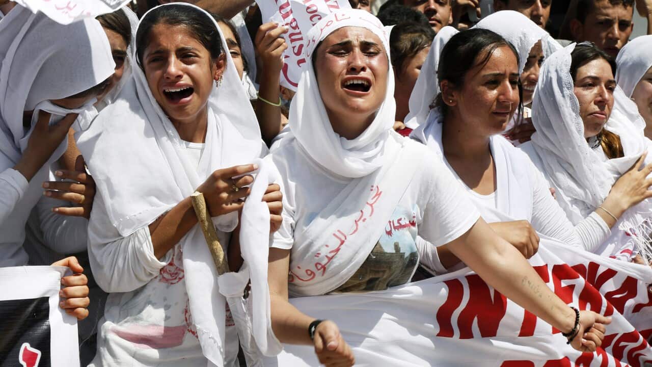 Yazidi Kurdish women chant slogans during a protest against the IS group's invasion on Sinjar city