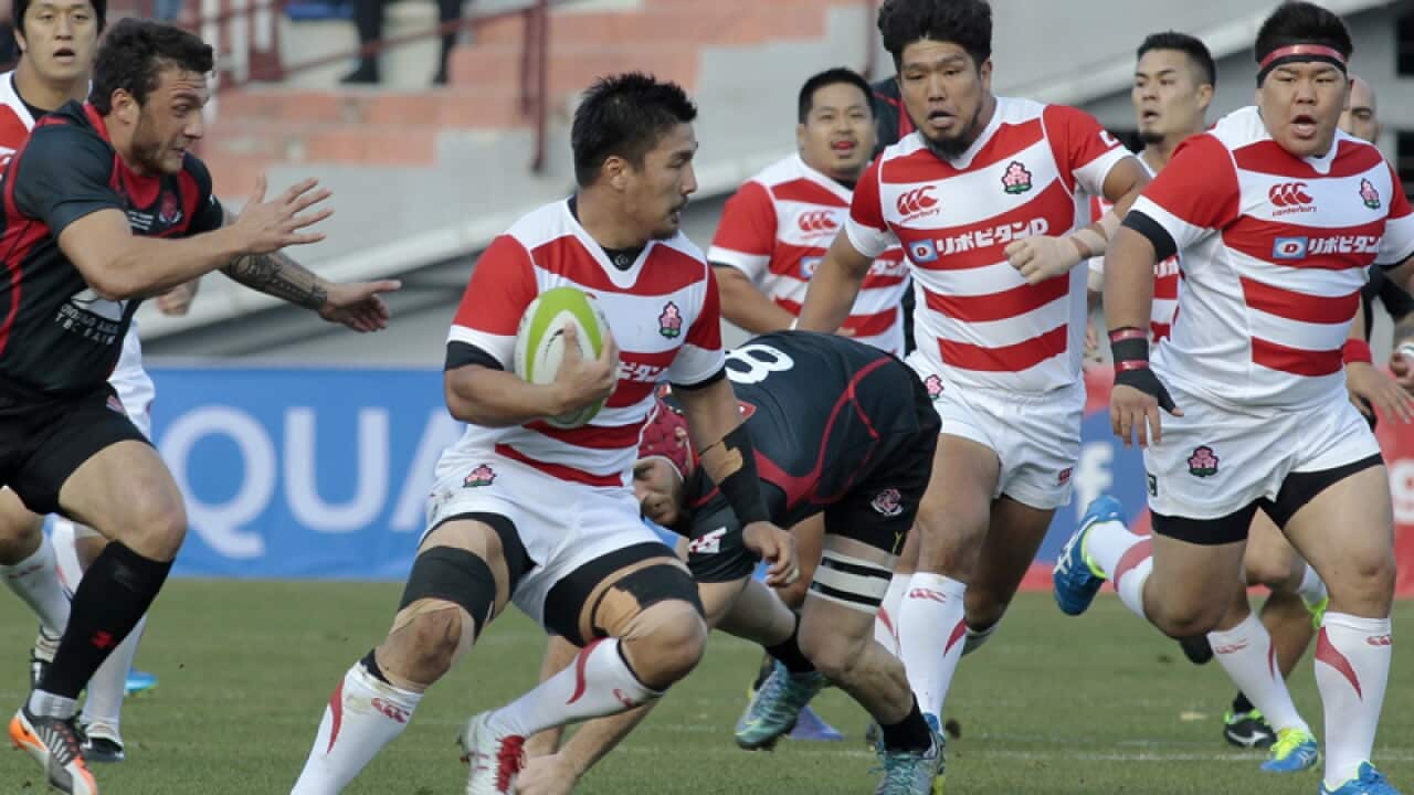 Georgia and Japan's players battle for the ball