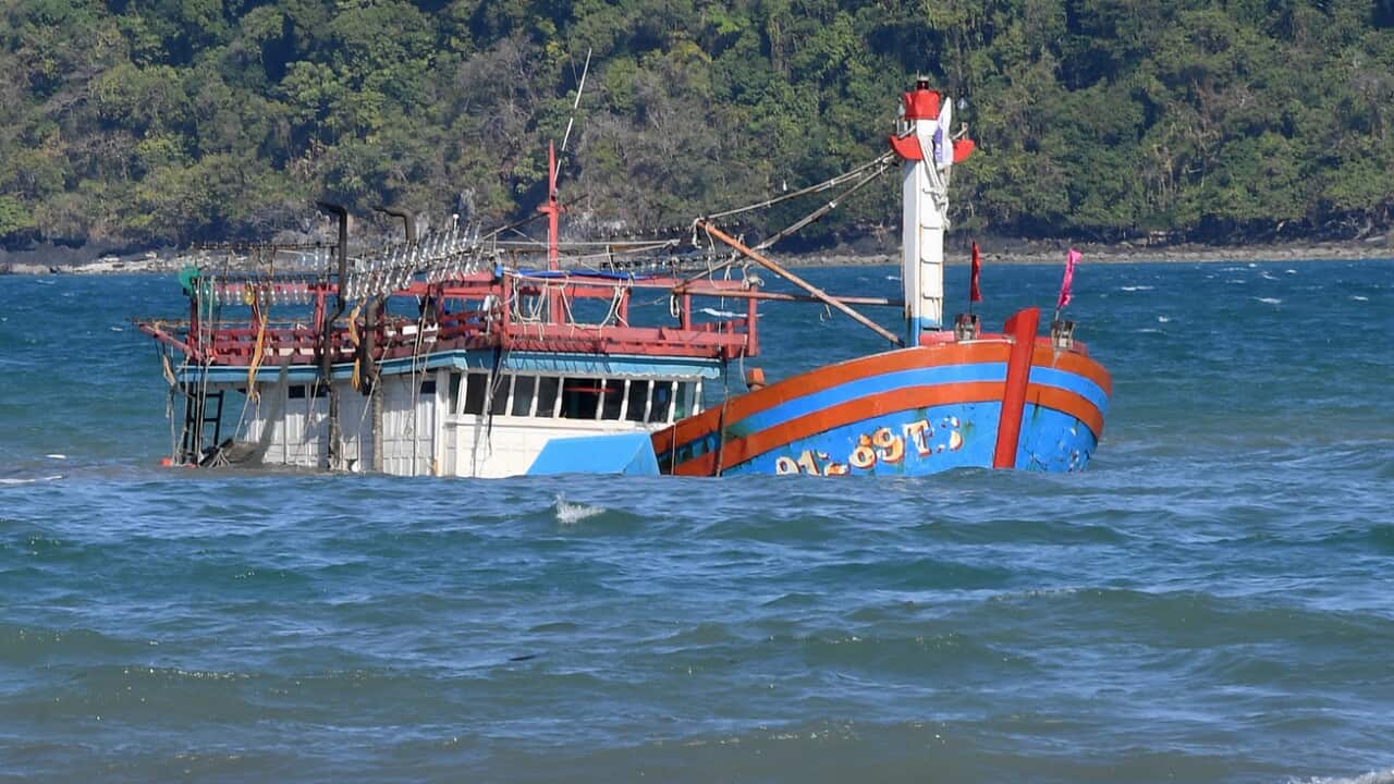 Queensland Police inspect a sunken vessel, believed to have been carrying Vietnamese asylum seekers