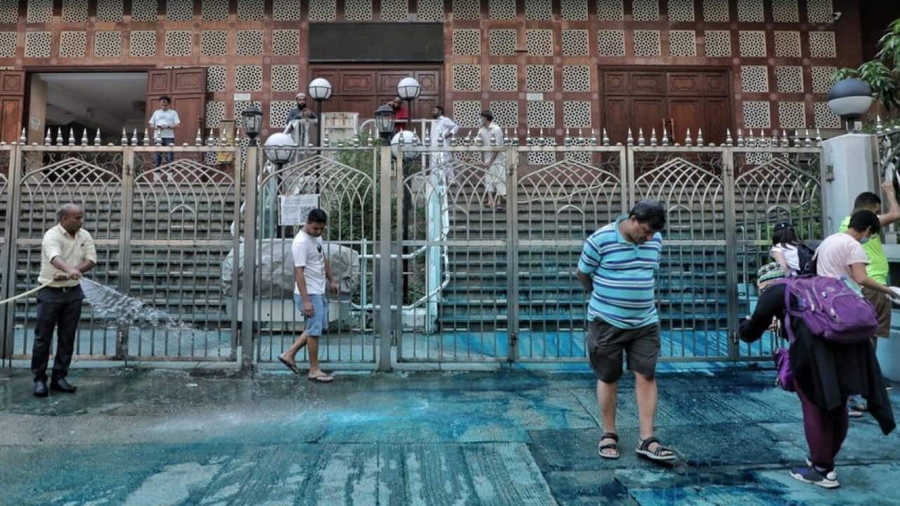 Volunteers help clean up Kowloon Mosque in Tsim Sha Tsui on Sunday after a police water cannon sprayed the building with blue-dyed water