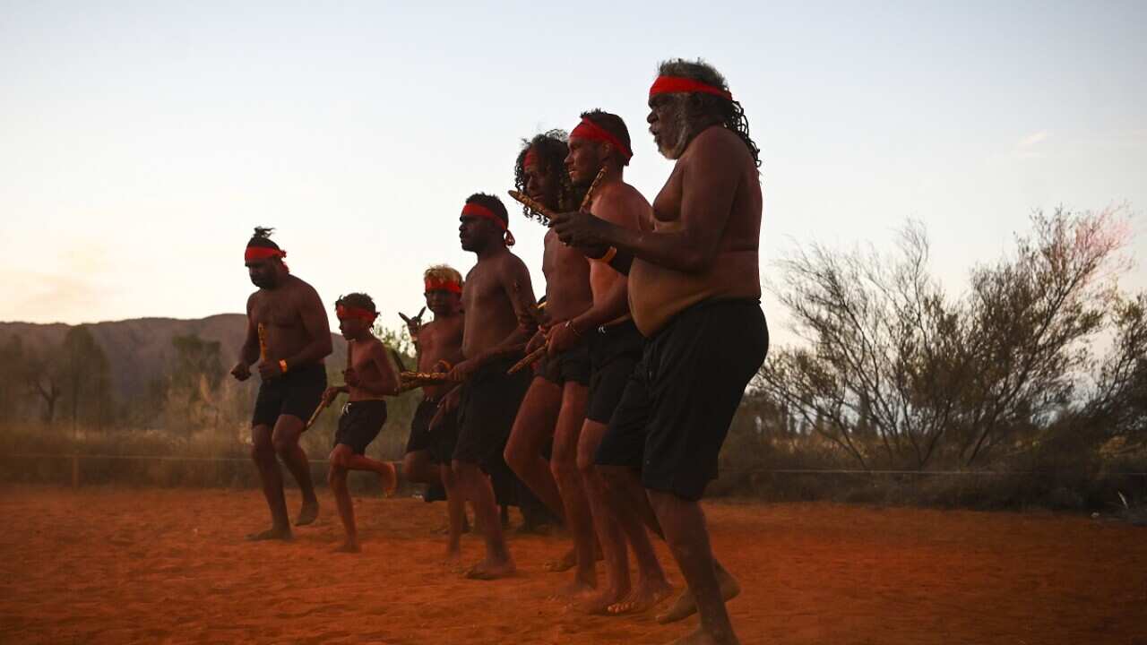 Traditional dancers perform during the official ceremony to celebrate the closure of the climb at Uluru on 27 October 2019.