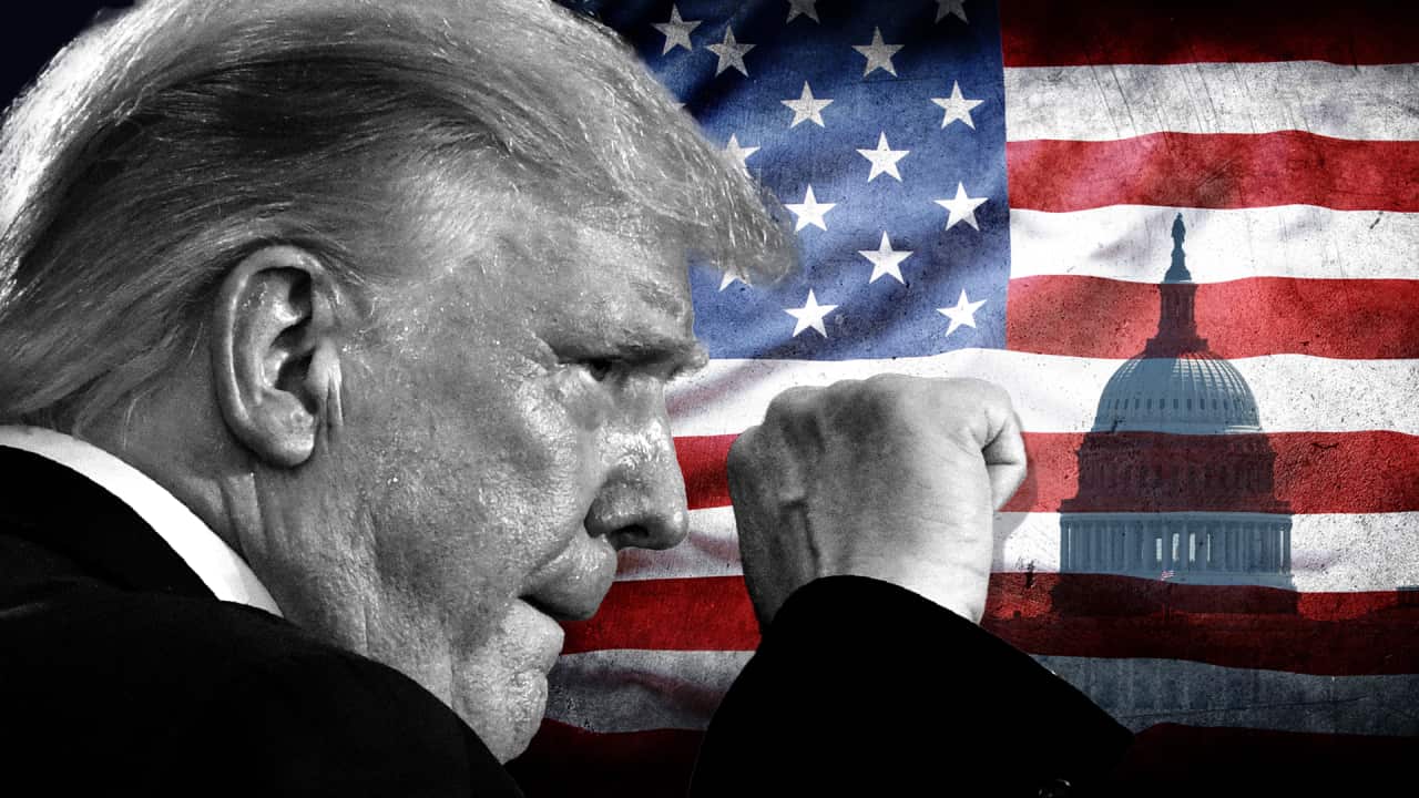 A black and white image of Trump with a raised fist close up, on a stylised background of a US flag and the US Capitol building.