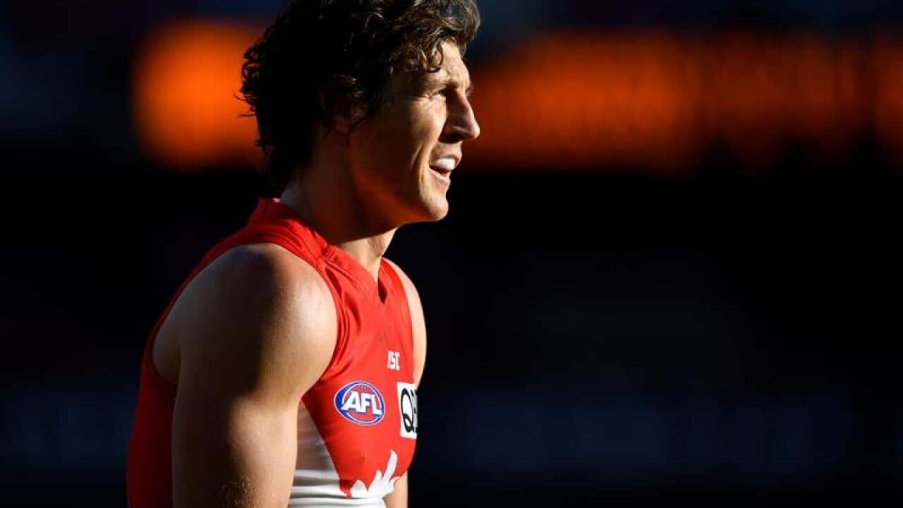 Kurt Tippett stands on field in his Sydney Swans jersey.