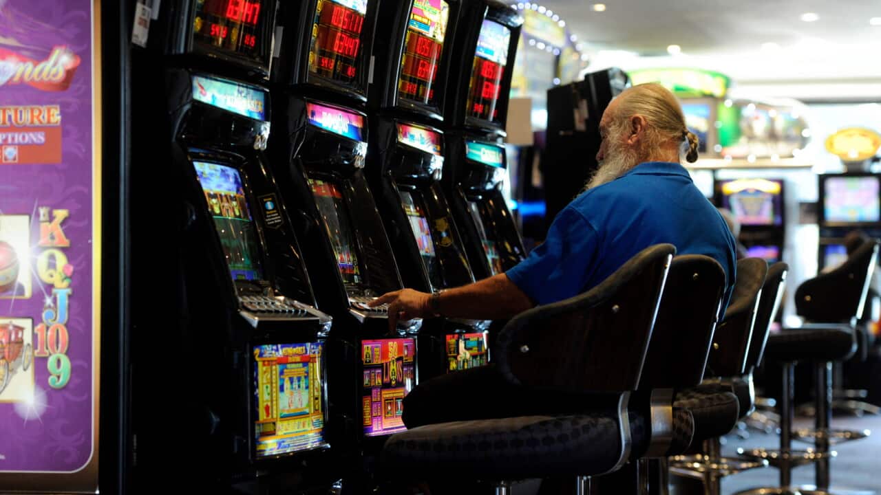 A man plays poker machines