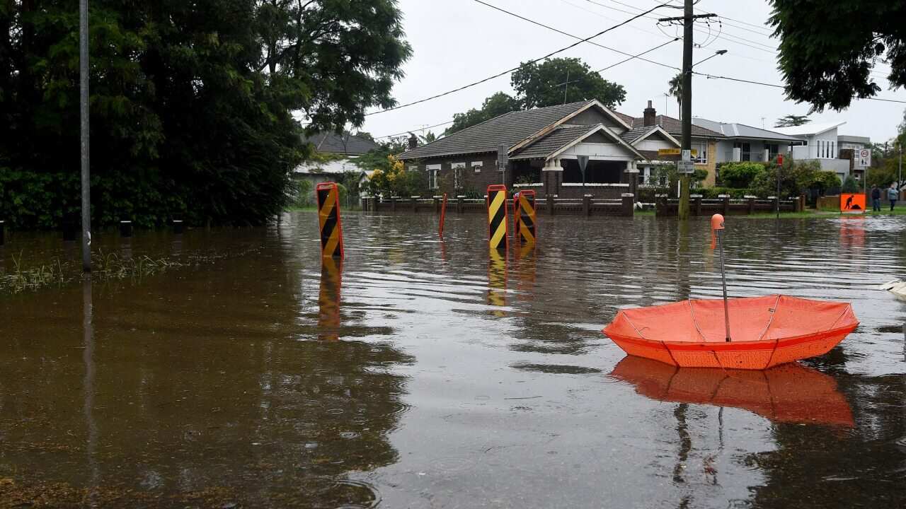 Floodwater submerges the road on the corner of Landbury Ave and Memorial Ave, Penrith, NSW.