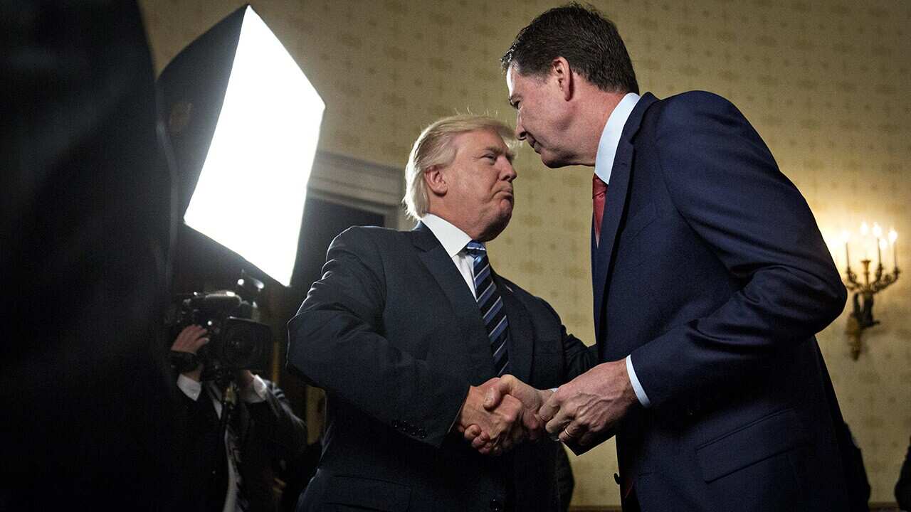 President Donald Trump, left, shakes hands with James Comey, then director of the Federal Bureau of Investigation (FBI).