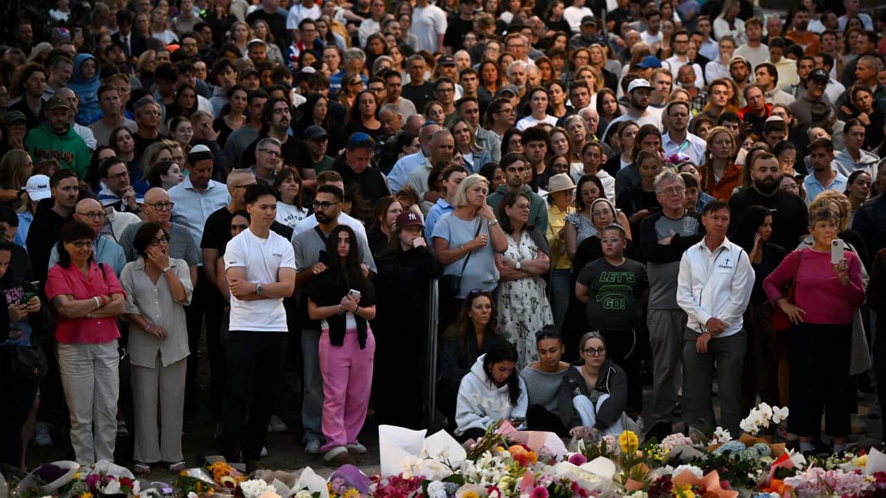 Mourners attend a vigil at a memorial in Bondi Beach, Sydney