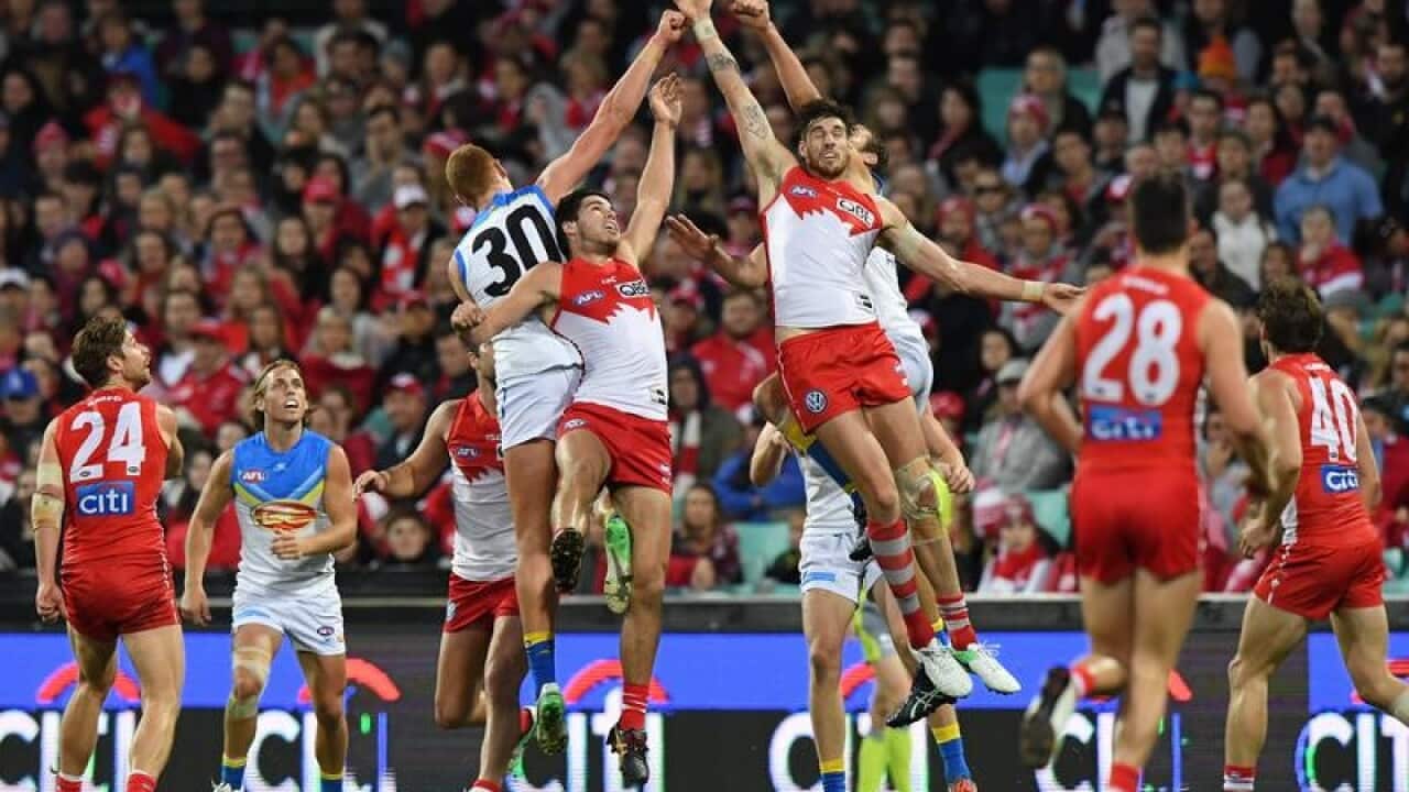 Swans and Suns players jump for a high ball