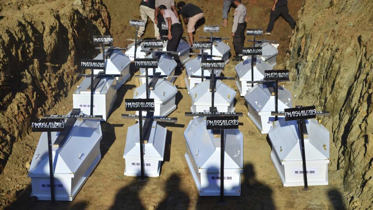 Flash floods victims are buried in a mass grave in Sentani, Papua province, Indonesia.