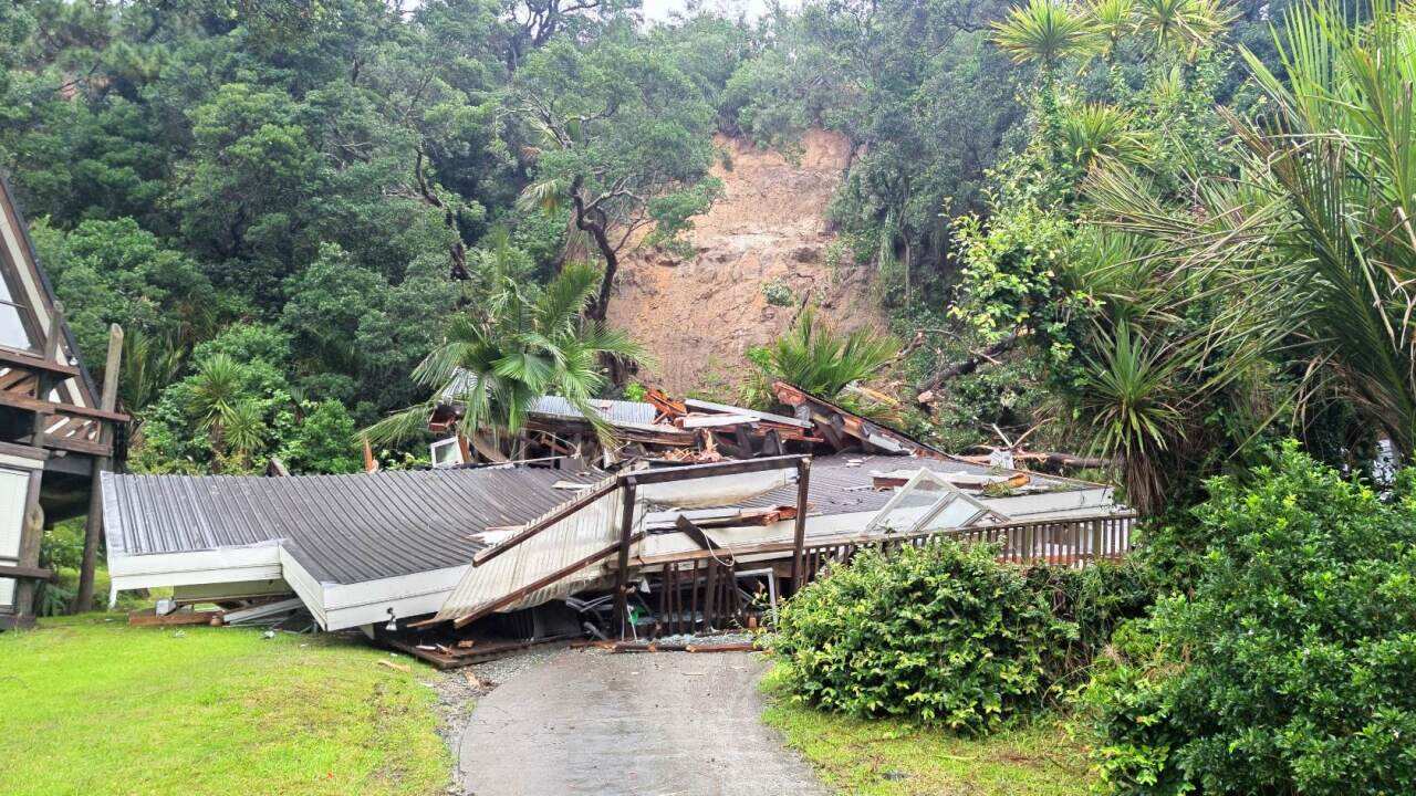 A house has collapsed at Domain Crescent in Muriwai Beach, after a mud slide caused by wild weather from cyclone Gabrielle, 14/02/2023