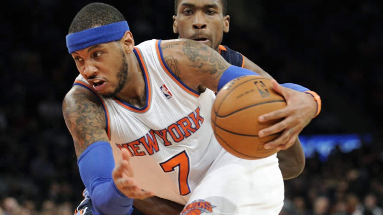 Carmelo Anthony (7) drives by Michael Kidd-Gilchrist