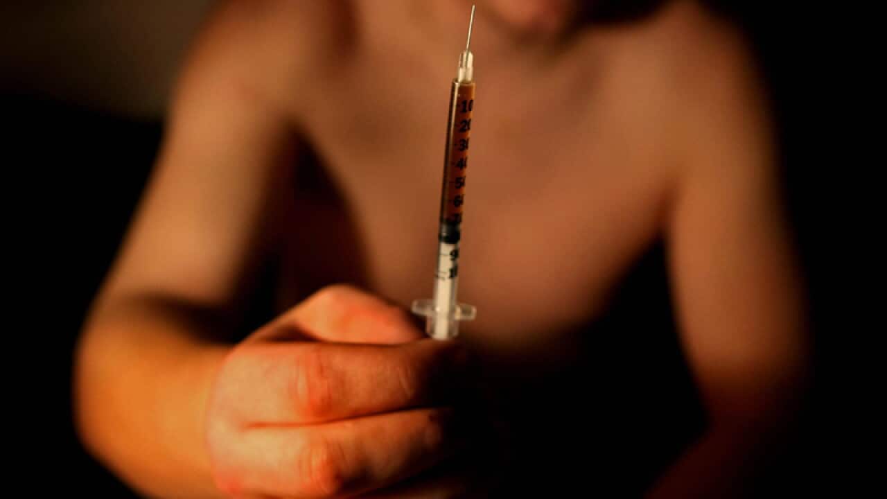 A drug addict with a syringe of drugs