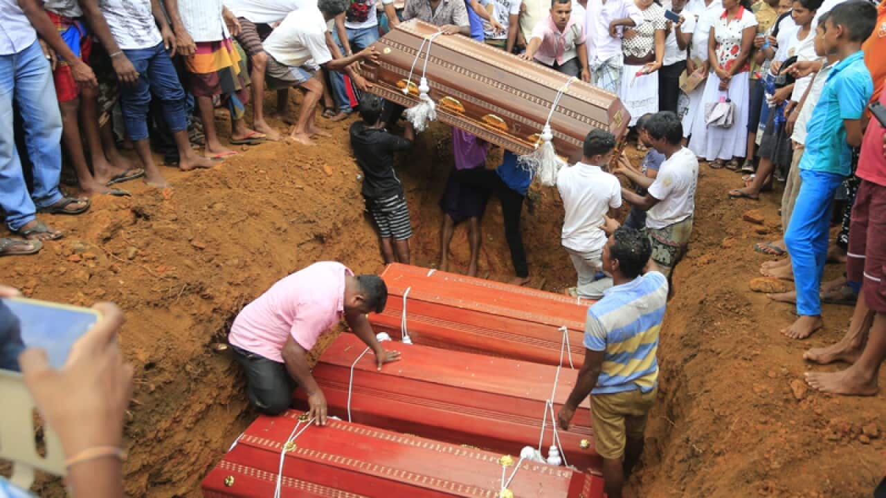 Sri Lankan villagers bury coffins
