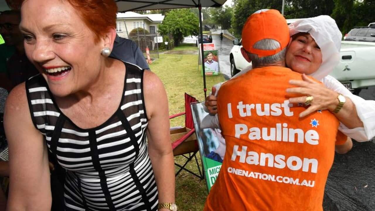 Pauline Hanson smiles as Jo-Ann Miller hugs a One Nation supporter.