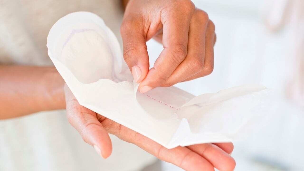Woman holding sanitary towel