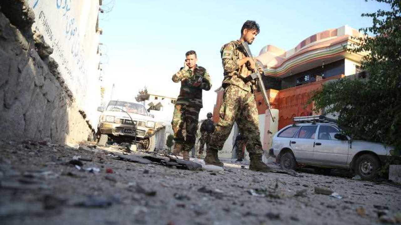Afghan security officials secure the scene of an attack by suspected militants at a refugee center in Jalalabad, Afghanistan, 31 July 2018.