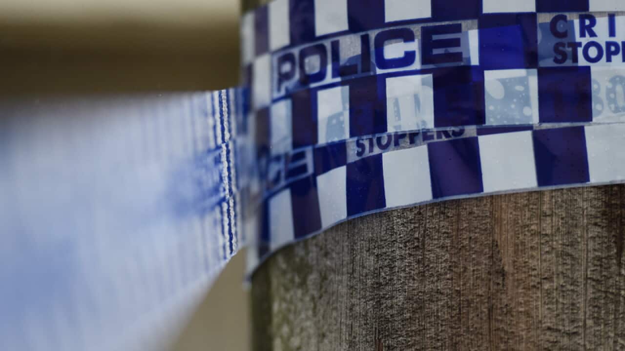 Police tape is seen at a home
