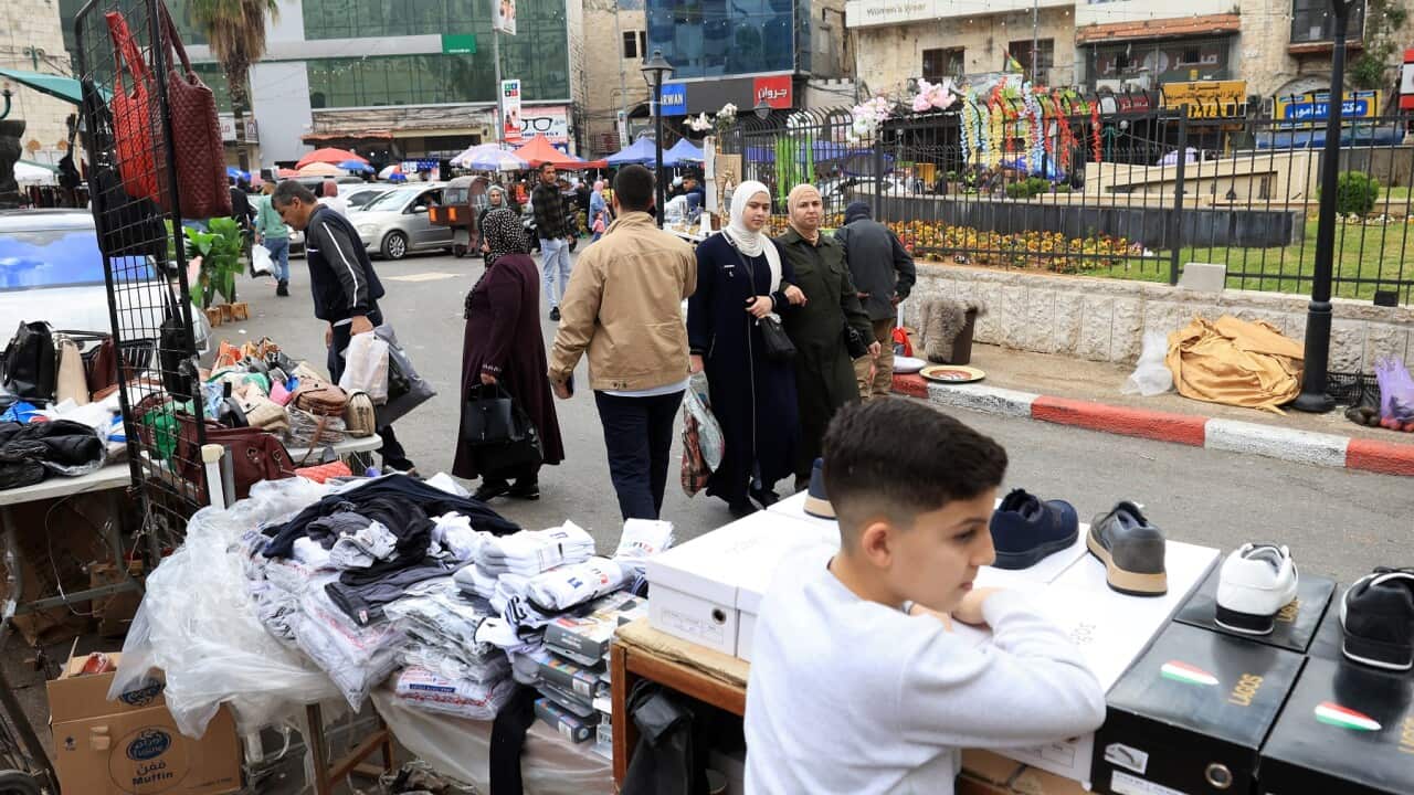Palestinians visit a market ahead of the Eid al-Fitr in Nablus