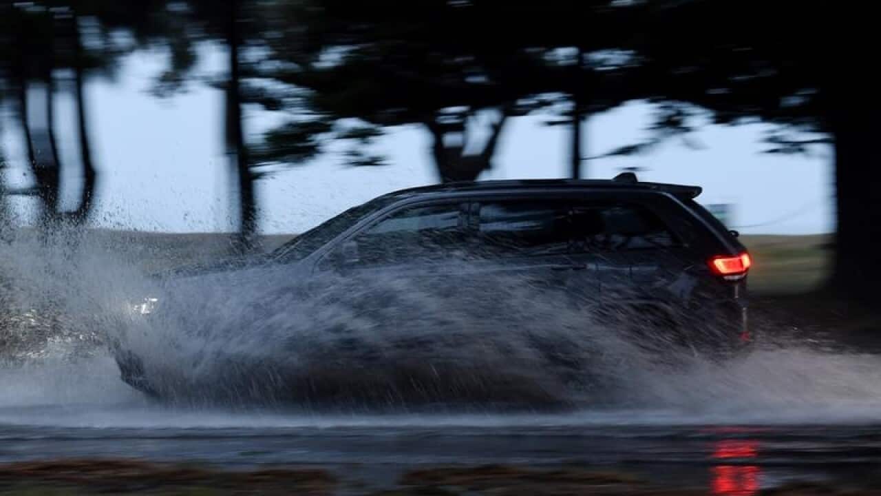 A vehicle negotiates a flooded road at Brighton Le Sands, Sydney.