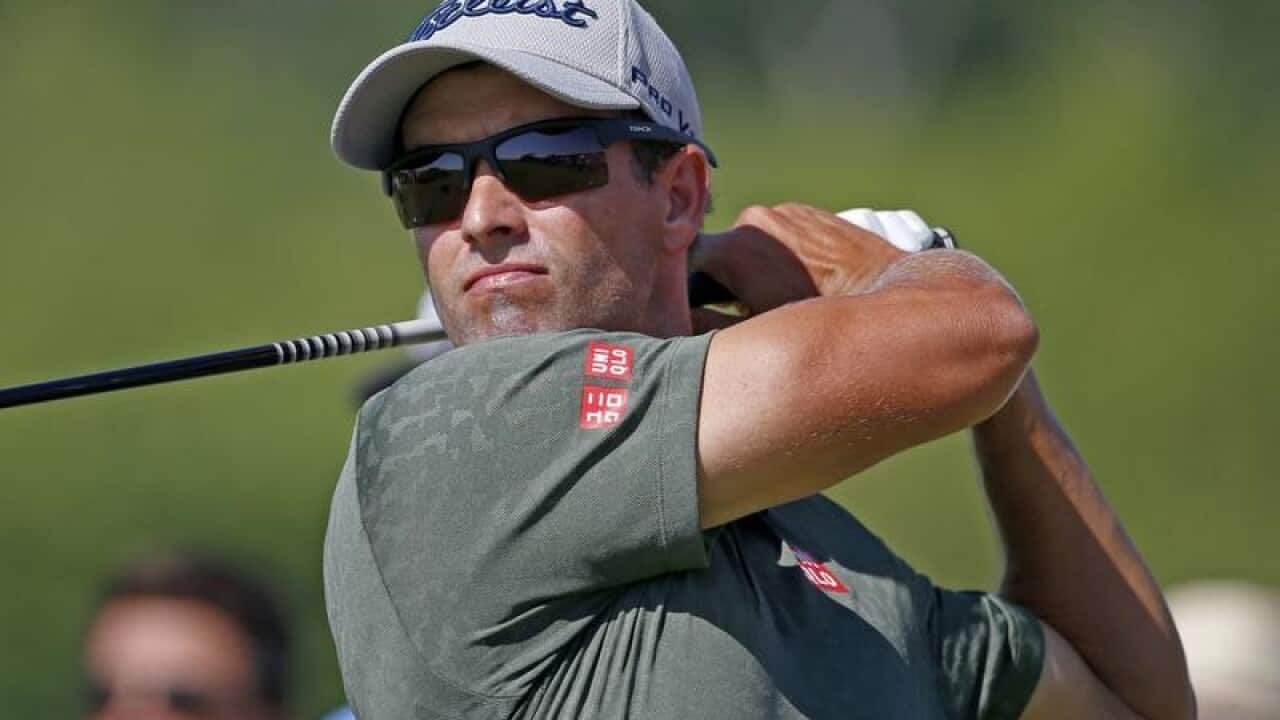 Australian Adam Scott watches his tee shot.