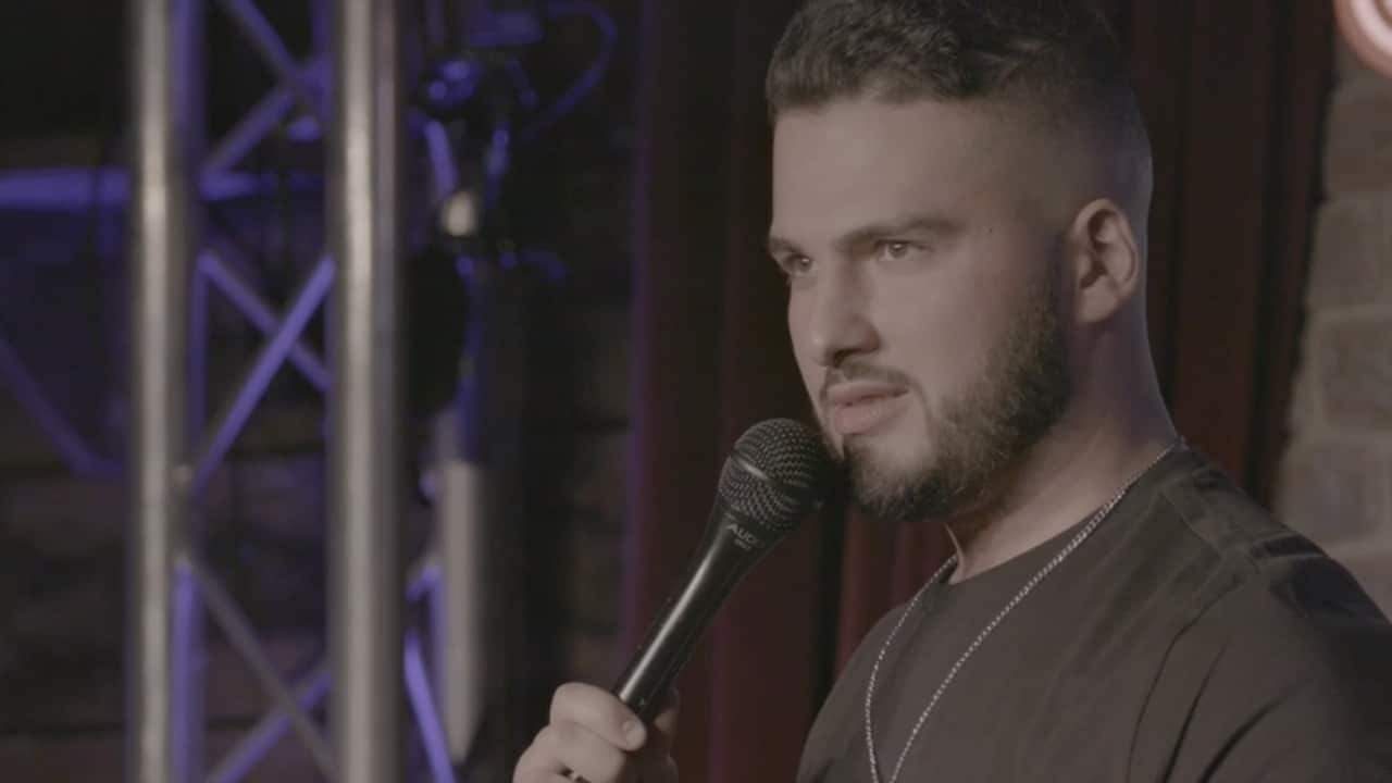 Kae Kurd on stage at his stand-up comedy show Kurd your Enthusiasm