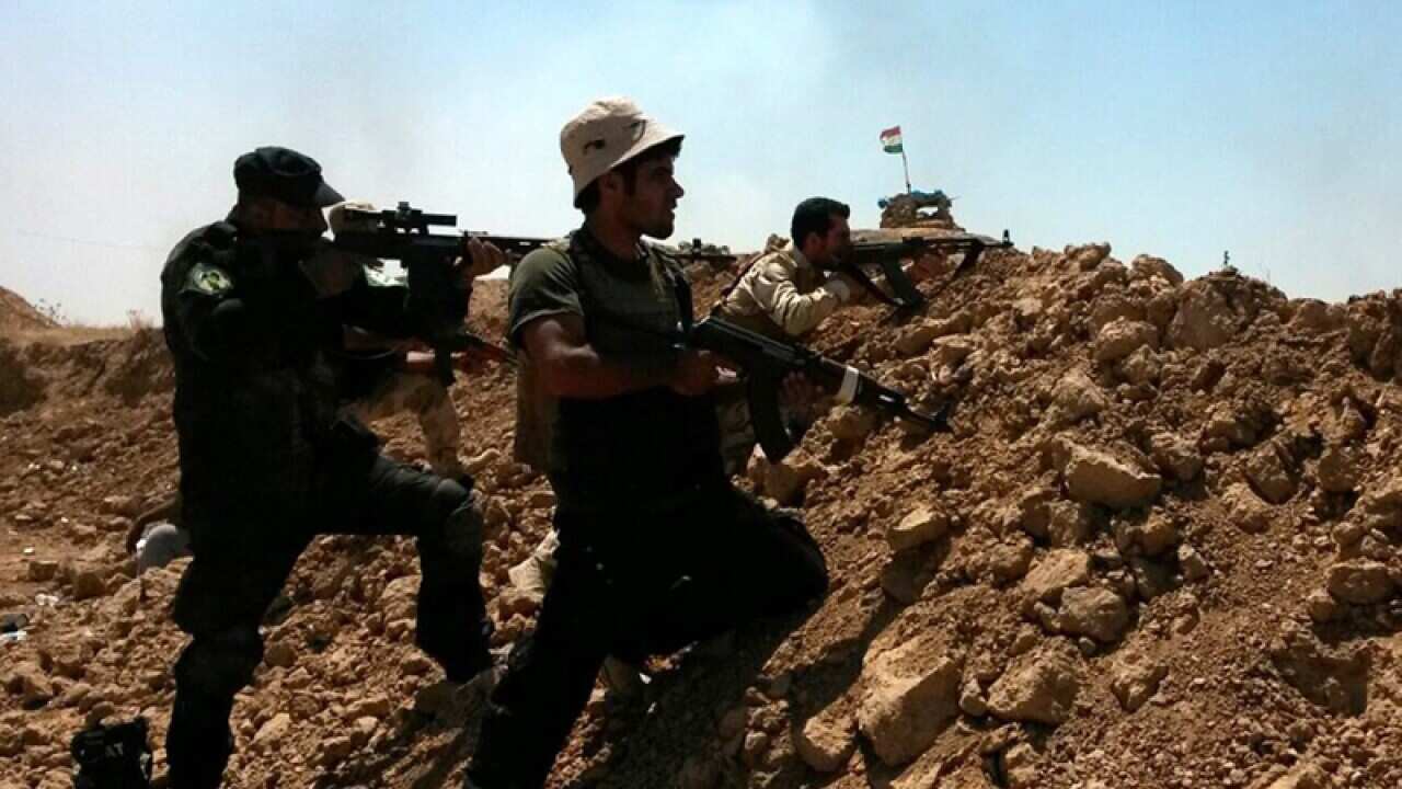Soldiers of the Kurdish Peshmerga forces and Shiite volunteers