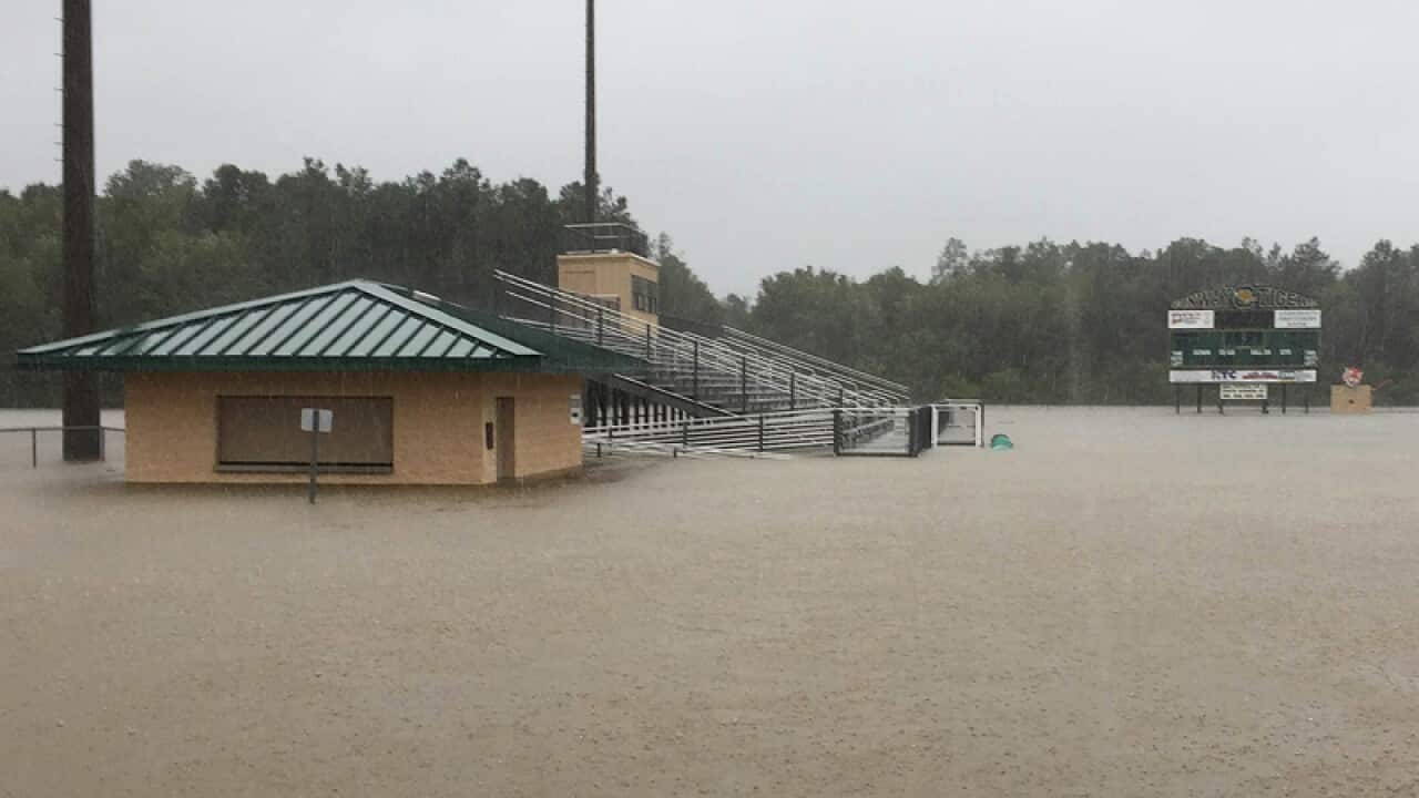 The football field at Conway High School is flooded by rain