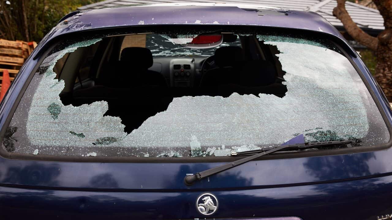 A car with damaged windows is seen after a hail storm overnight in Berowra Heights, NSW.