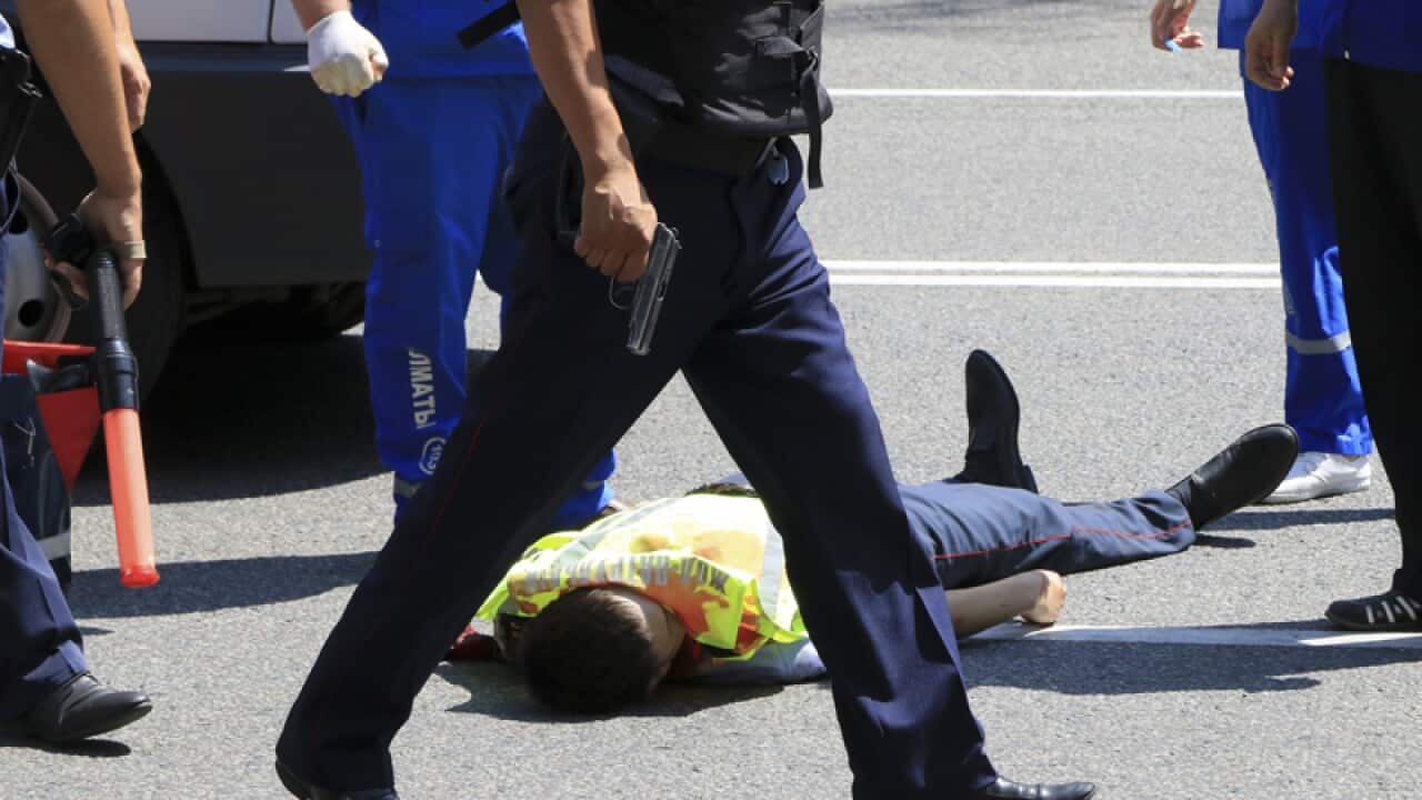 Police stand near a body of a killed police officer