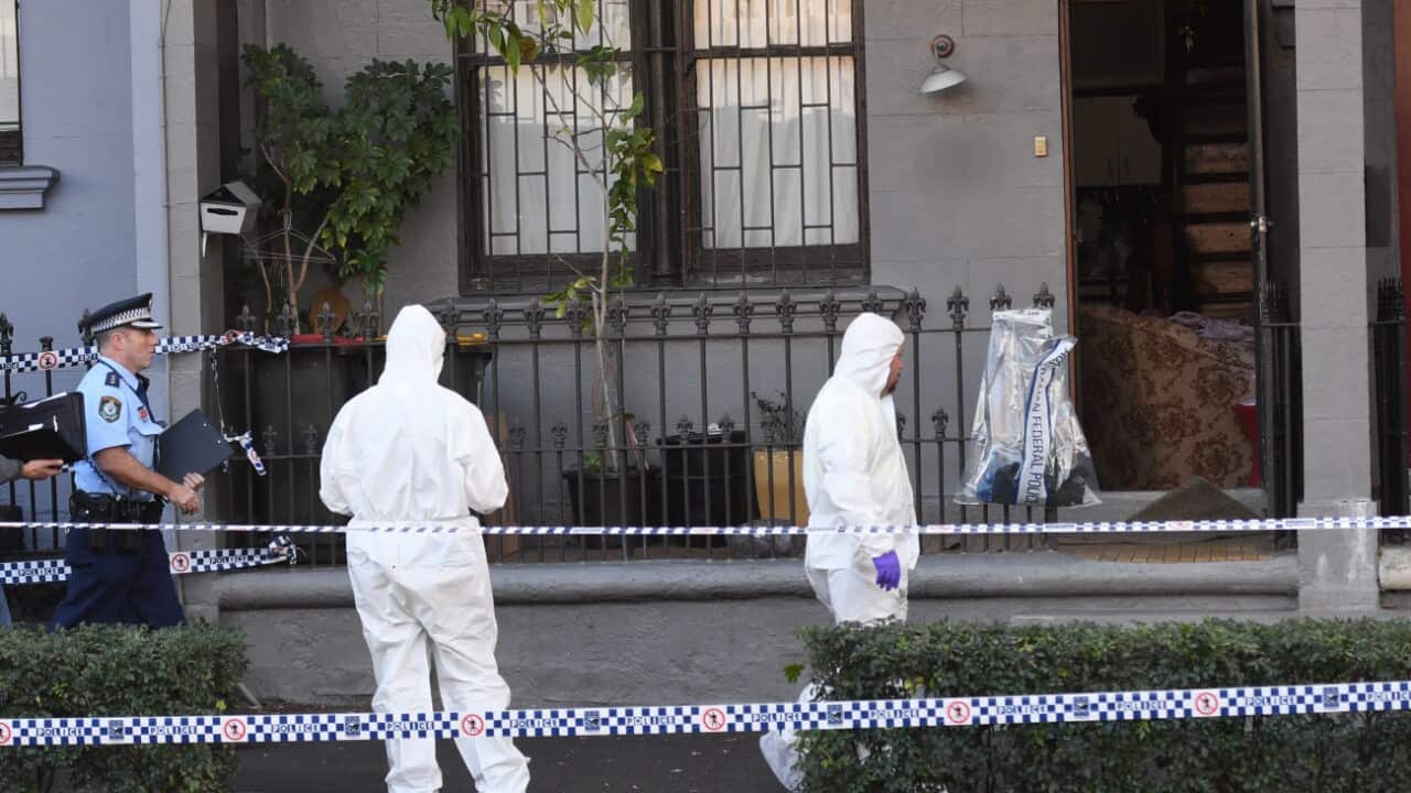 Federal and State Police officers are seen at a crime scene