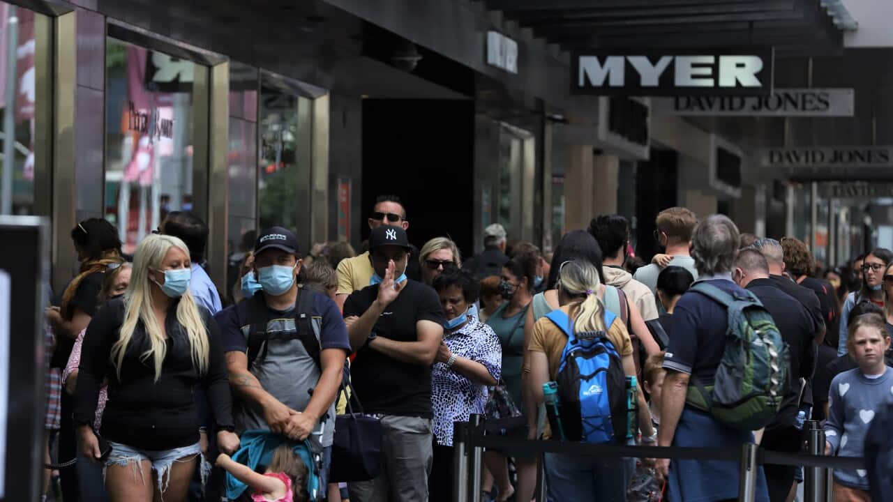 People wait to check Myer Christmas windows along Bourke Street Mall in Melbourne on 5 December 2021.