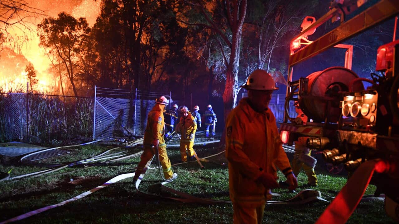 Firefighters fight flames close to homes in Corryton Court, Wattle Grove in Sydney, Saturday, April 14, 2018. 