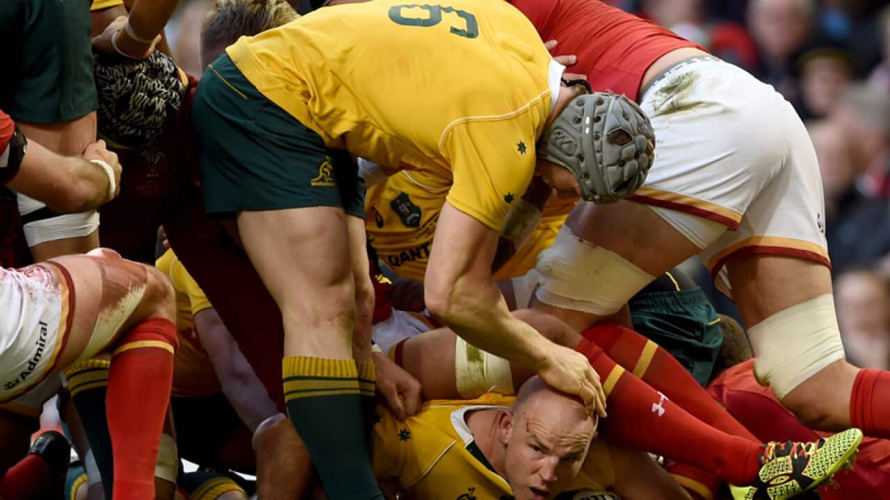 Australia's Stephen Moore (bottom) scores a try against Wales