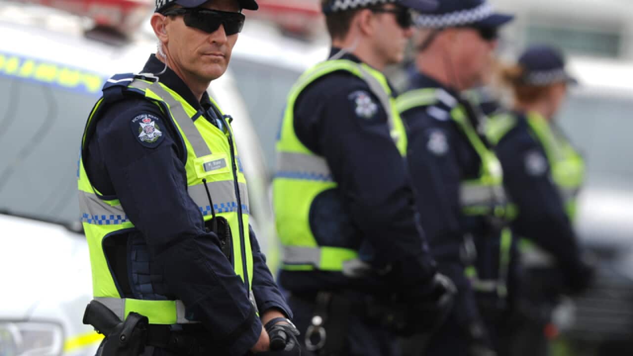 Police stand guard outside a Hells Angels fortified club house
