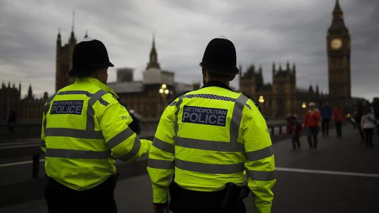 Police officers patrol Westminster Bridge with the Houses of Parliament in the background. (AP)