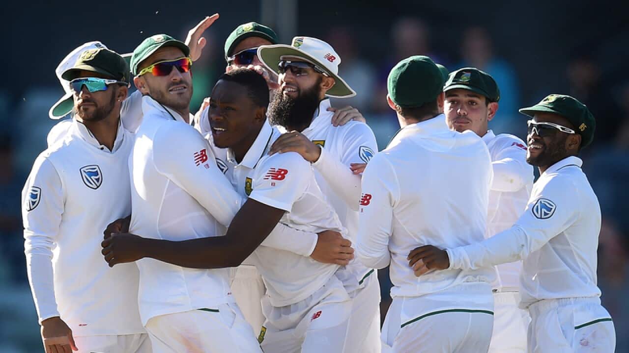 South African bowler Kagiso Rabada (centre) reacts with team mates