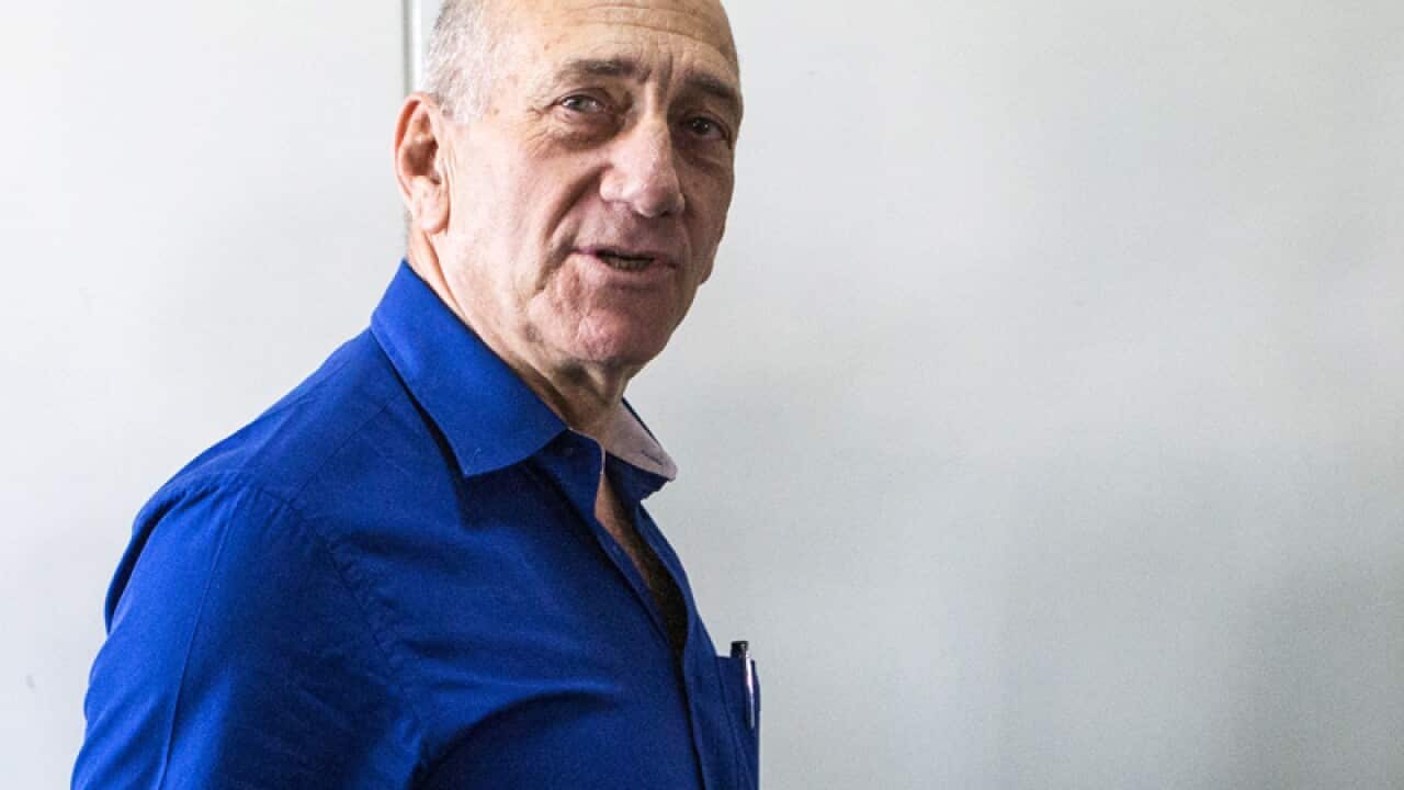 Former Israeli Prime Minister Ehud Olmert leaves district court