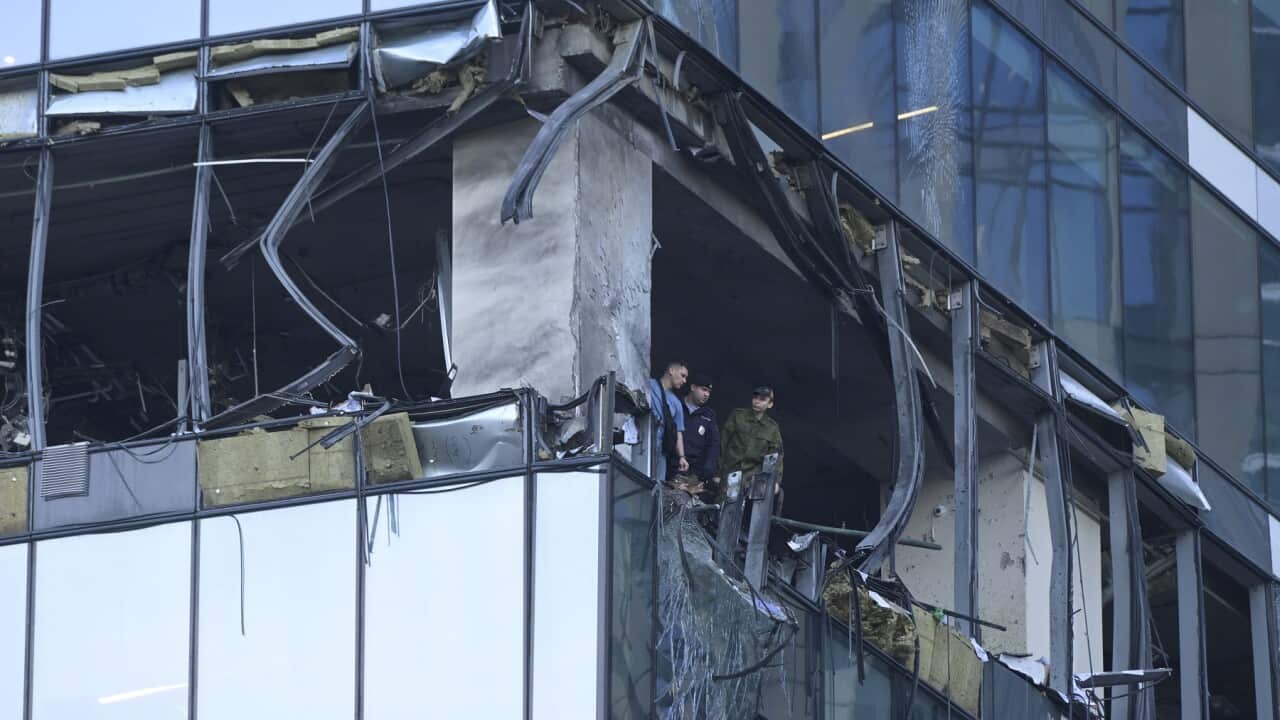 Investigators examine a damaged skyscraper in the Moscow City business district after a reported drone attack (AAP).