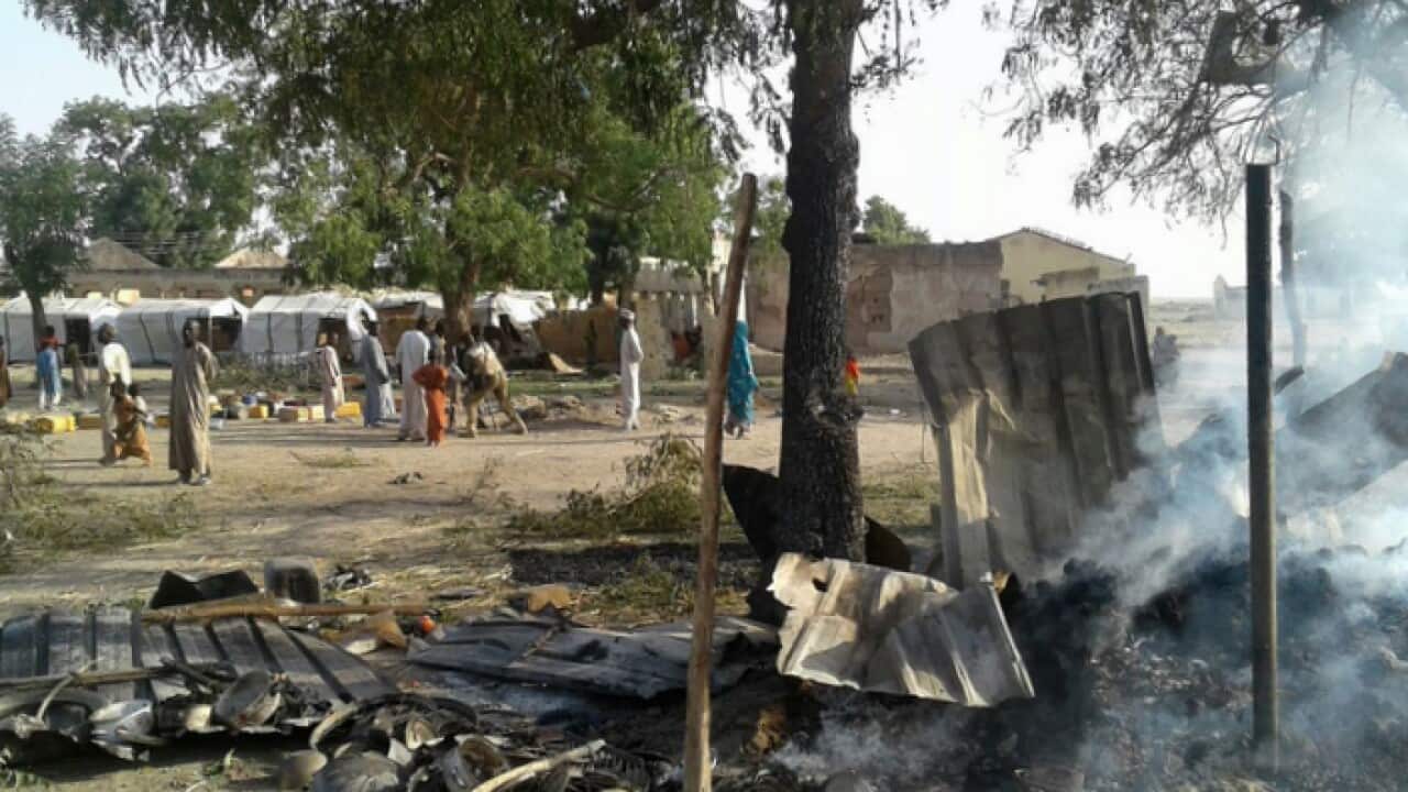 Smoke rises from a burnt out shelter at a camp for displaced people in Rann, Nigeria (AAP).jpg