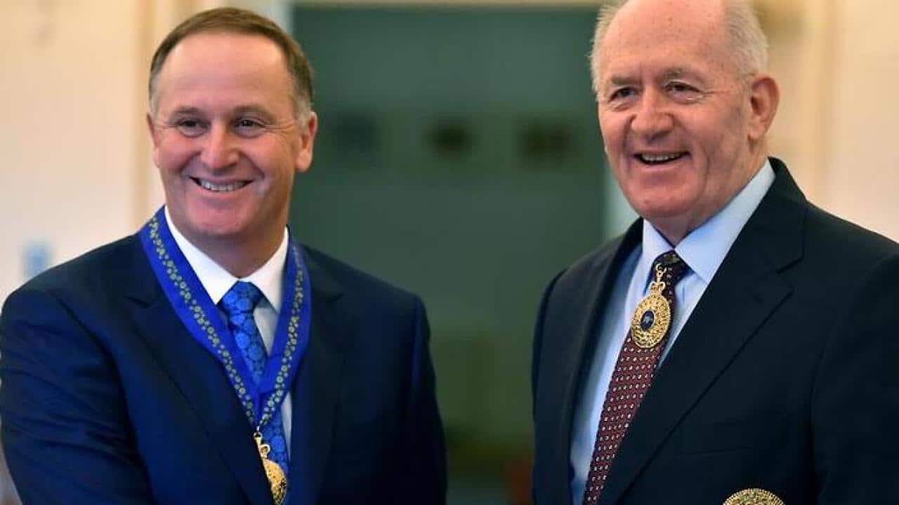 Ex-NZ prime minister John Key receives his honour from Governor-General Peter Cosgrove.