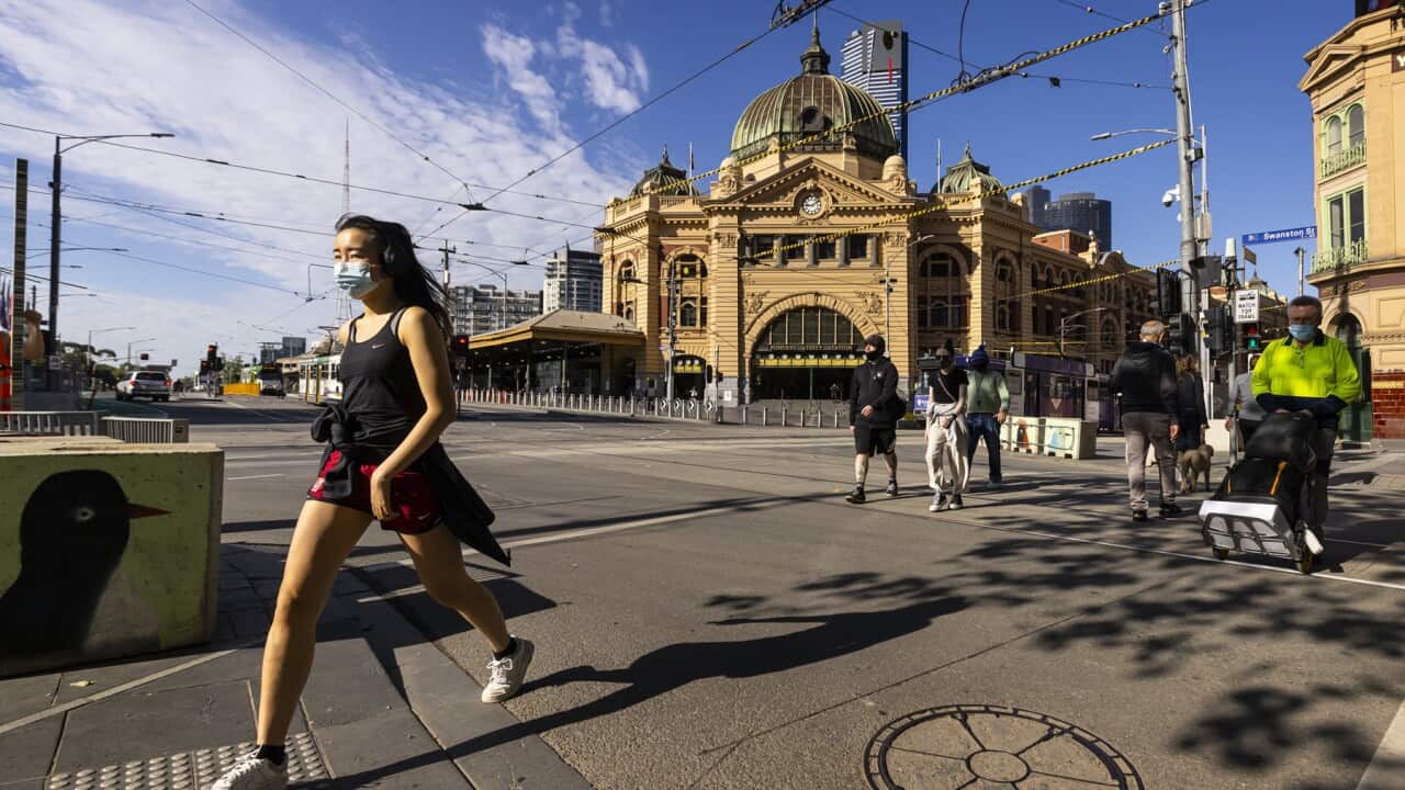 Pedestrians walk from Flinders St station in Melbourne (AAP).jpg
