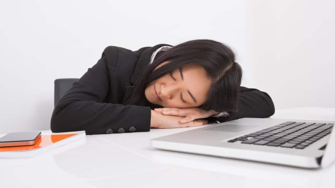 Exhausted businesswoman resting at office desk