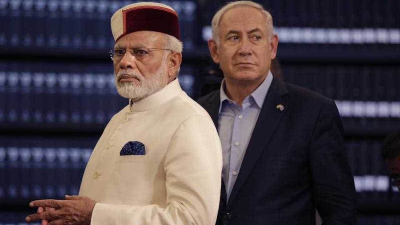Indian Prime Minister Narendra Modi, left, accompanied by Israeli Prime Minister Benjamin Netanyahu, right, visits the Yad Vashem Holocaust memorial museum in Jerusalem, Tuesday, July 4 2017.