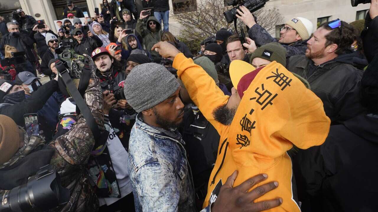 Protesters argue outside the Kenosha County Courthouse after teenager Kyle Rittenhouse was acquitted of all charges.