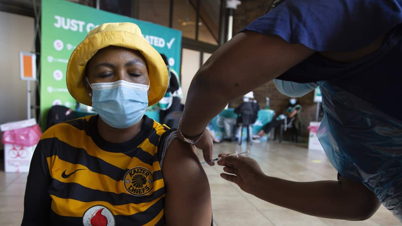 A woman receives a vaccine in South Africa